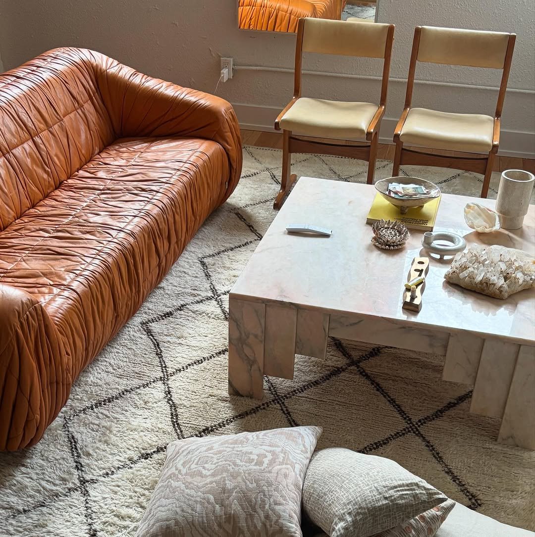 Living room with a pleated cognac leather sofa and Moroccan rug